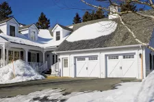 This garage door is an Eastman E-21 design, 9' x 7' size, Ice White doors and overlays, 8 lite Orion windows.